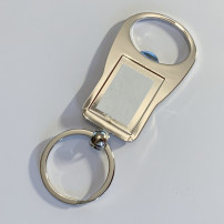 Porte-clé décapsuleur en métal argenté ovale 3,5 x 9,5 cm (vendu à l'unité)